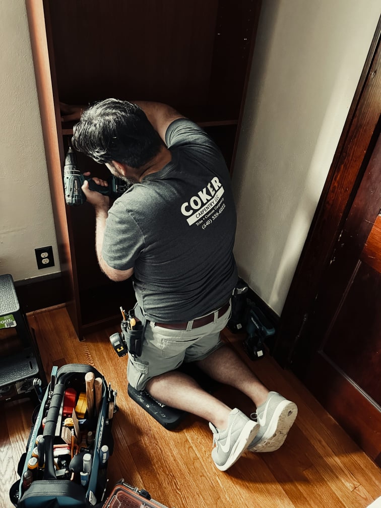 Photo of the founder of Coker Carpentry at a job site while framing a house.
