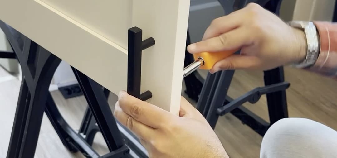 Photo of Coker Carpentry LLC installing a cabinet door pull onto a cabinet door in Roanoke, Virginia.